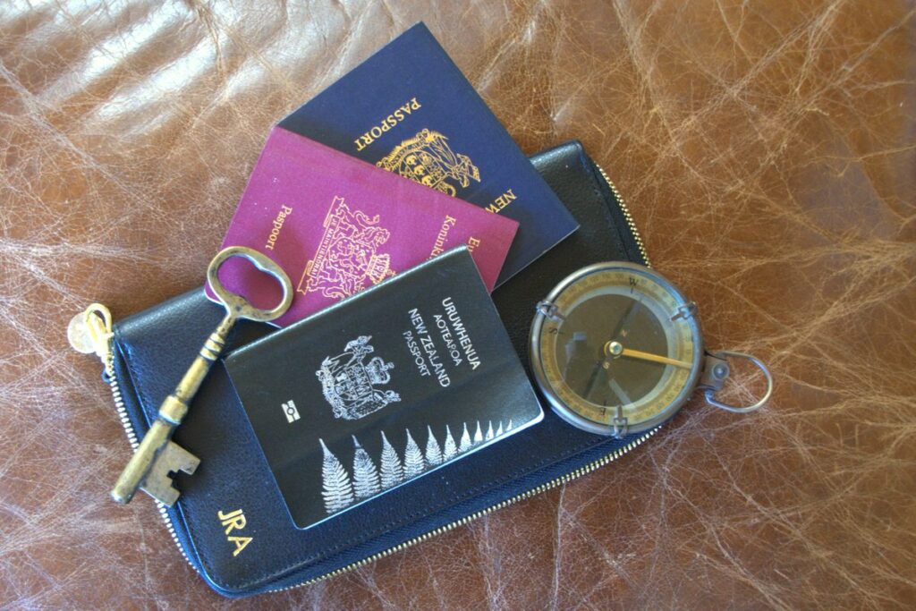 Passports, compass and key for arriving in New Zealand
